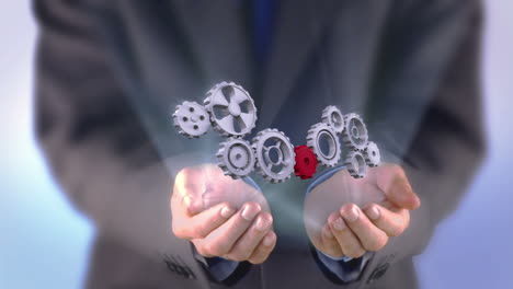 Businessman-presenting-cogs-and-wheels-graphic