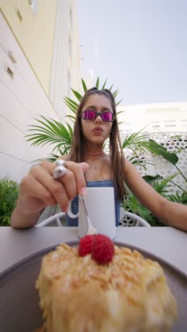 young woman enjoying dessert at an outdoor cafe