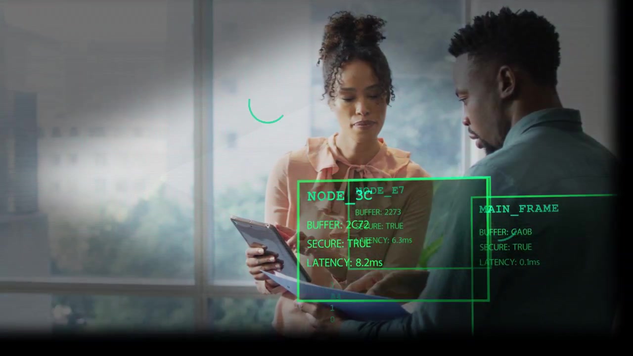 Woman tapping tablet, man holding papers, green HUD animating over them, comparing business data