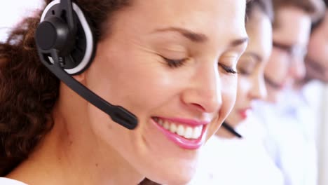 Row-of-call-centre-agents-working-at-their-desk