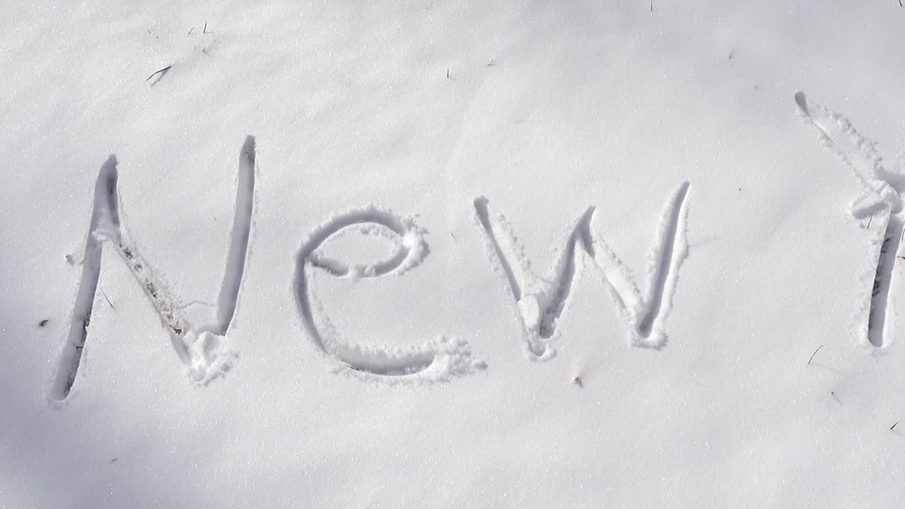 Inscription of happy new year on snow. Shooting in the winter