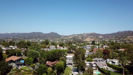 aerial rising wide shot showing luxury neighborhood of pacific palisades in los angeles