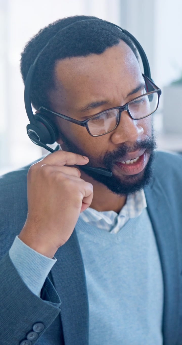 Professional Man Wearing Headset Talking in Office