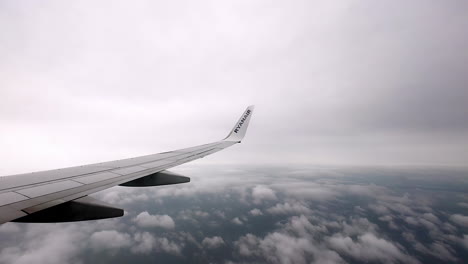 Shot-while-through-porthole-on-wing-of-commercial-plane-flying-over-Latvia-on-a-cloudy-day