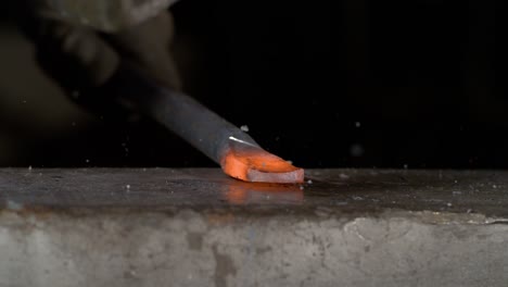 Blacksmith-hitting-a-hot-steel-piece-on-an-anvil-in-super-slow-motion