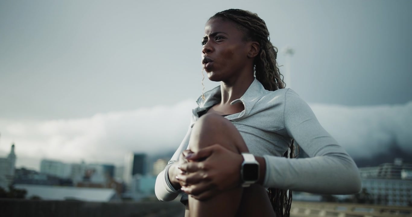 Young Woman Stretching and Exercising on Urban Rooftop