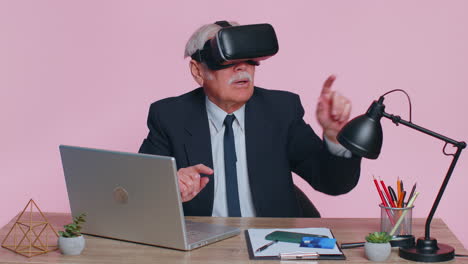 Senior-businessman-using-headset-helmet-app-to-play-simulation-game,-watching-virtual-reality-video