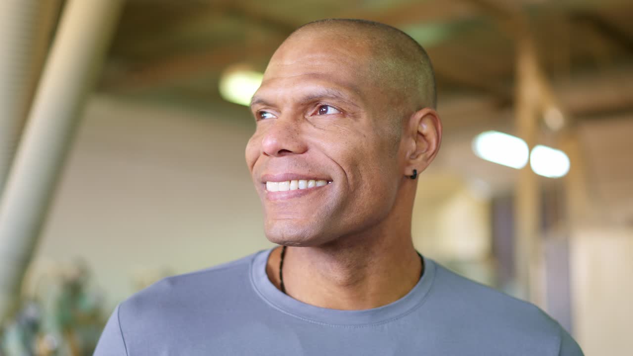 Close Up Portrait of a Happy Bald Man Smiling and Looking Away