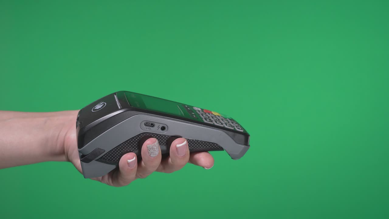Close up female hold in hand wireless modern bank payment terminal to process acquire credit card payments black card isolated on green screen. Copy space mock up advertising, man pay