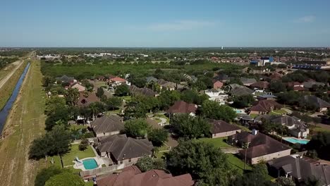 aerial view of suburban neighborhood with canal