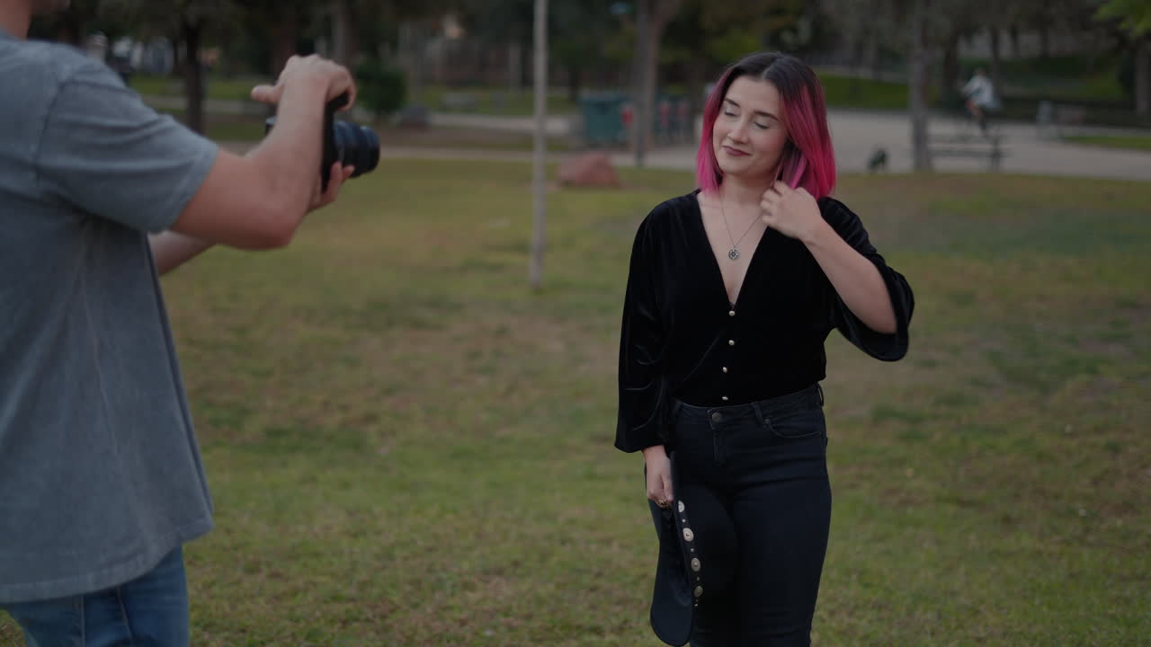 Photographer capturing a portrait of a woman in a park