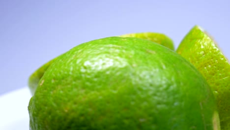fresh green lemon slice is slowly rotating in the studio with the details.
