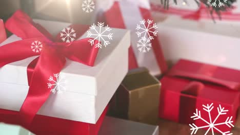 Animation-of-multiple-snowflakes-falling-over-christmas-presents-in-the-the-background