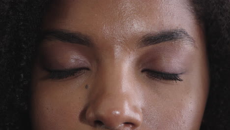 close up african american woman opening eyes blinking looking at camera iris reflection