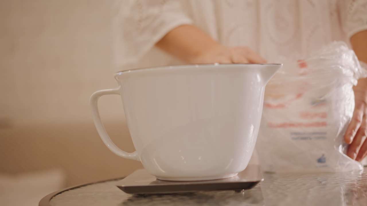 White ceramic bowl on scale, caucasian woman positions bowl and measures flour for pumpkin pie, lace dress sleeve, bag of flour, soft sunlight on countertop, careful hands arranging ingredients, warm