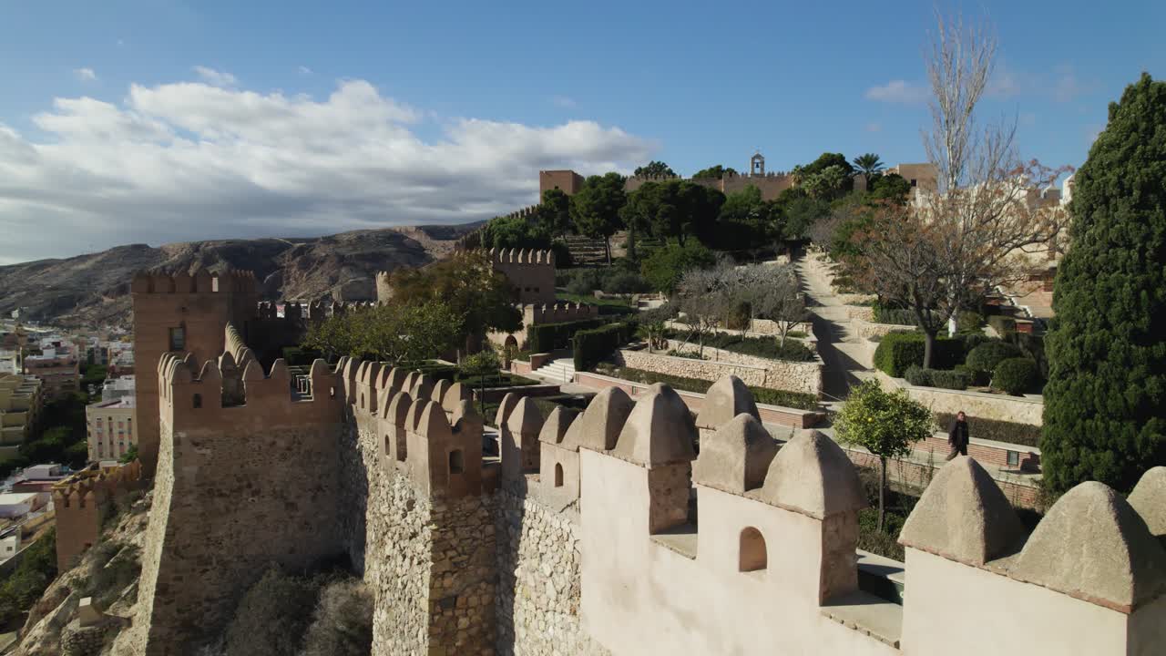dolly aéreo sobrante de la fortificación amurallada de la alcazaba de almería con jardines de fondo