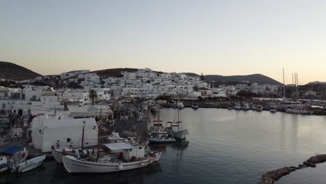 paros, naoussa, greece coastline and traditional white houses during sunset, aerial view