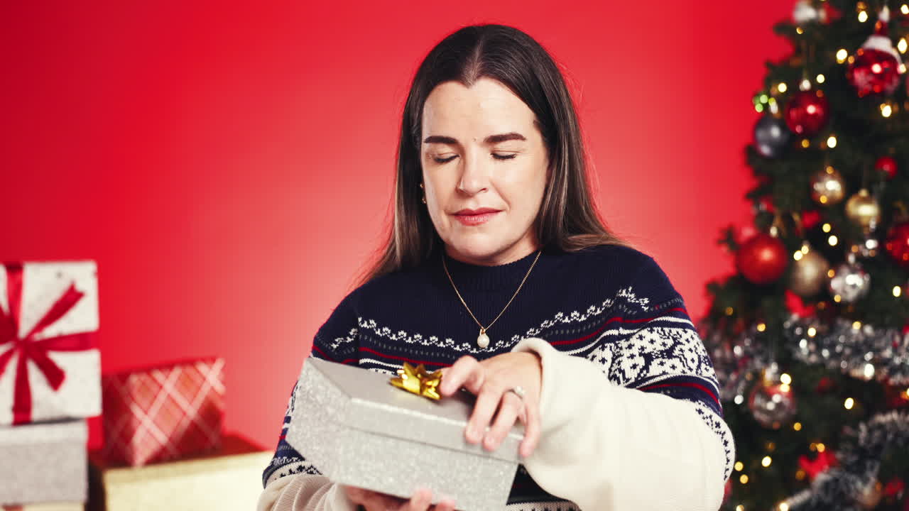 Woman opening a Christmas present
