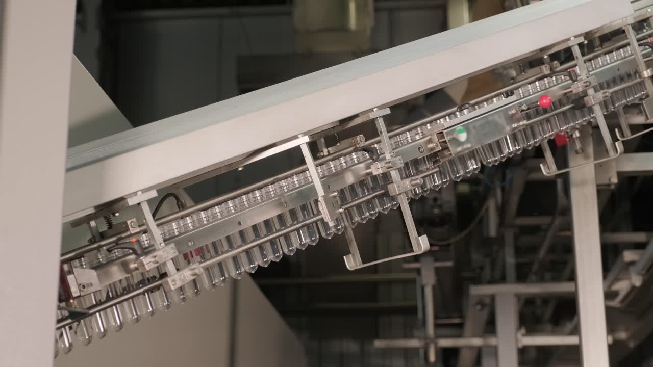Automatic filling machine pours water into plastic PET bottles at modern beverage plant