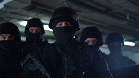 Police-forces-with-rifles-looking-at-camera.-SWAT-team-posing-in-building