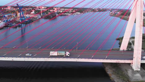 toma aérea de un camión que viaja en un puente atirantado en un río en gdansk, polonia