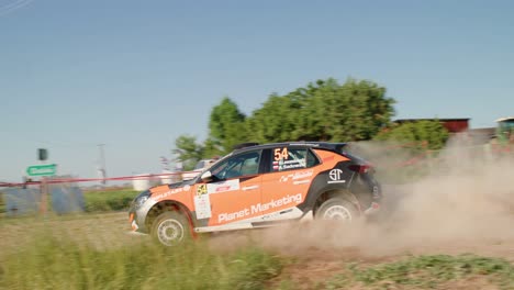 orange sport car taking a sharp turn in slow motion