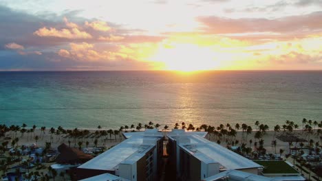 tropical sunset, sunrise above luxury vacation and holiday resort , aerial view of hotel with swimming pool and beach area with palms and blue ocean