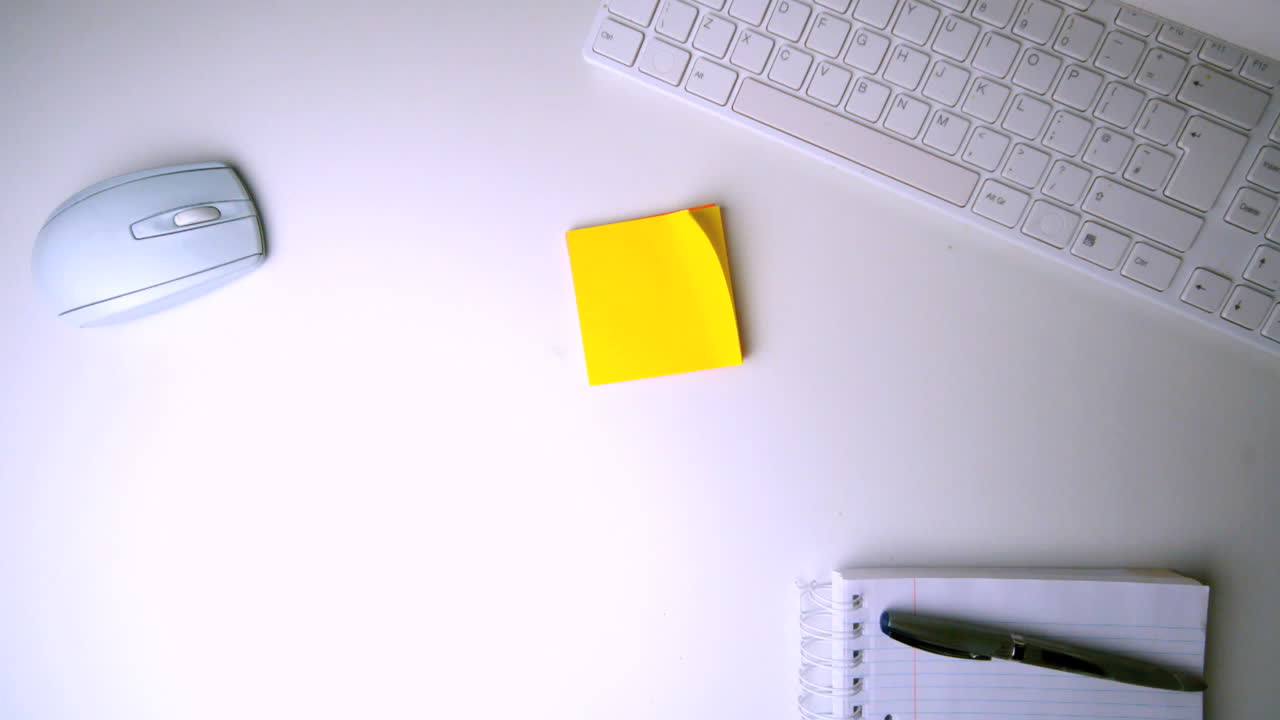 Yellow post it falling on office desk