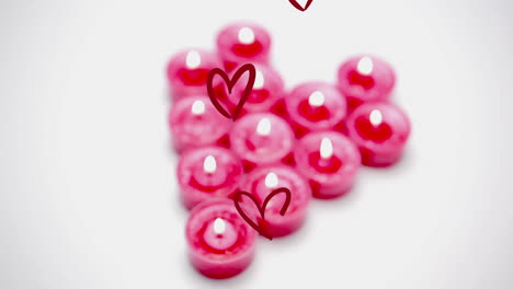 animation of multiple red hearts over pink candles