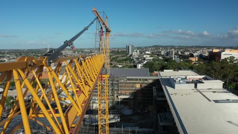 Drone shot of yellow crane in contraction site