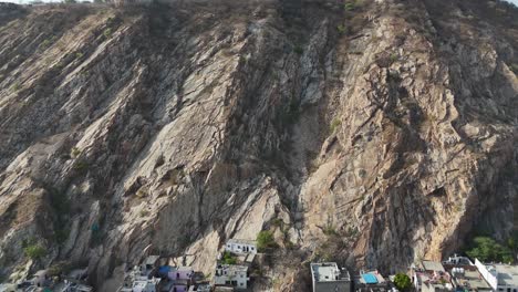 aerial view of a historic fort perched atop the rugged hills of jaipur.
