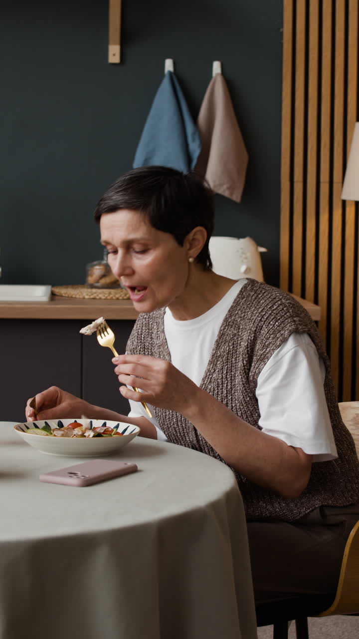 Woman Eating a Meal in a Modern Kitchen