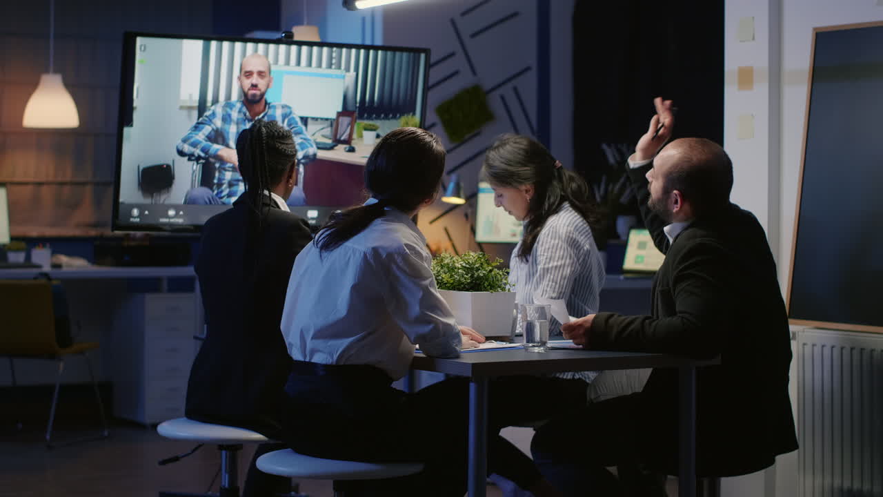 Diverse business teamwork analyzing with remote manager in wheelchair during online videocal