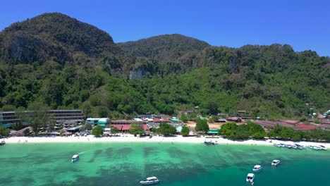 Tourists-boats-on-a-sunny-day-in-a-tropical-paradise-with-turquoise-water-and-limestone-cliffs