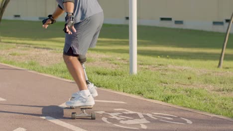 man with prosthetic leg riding skateboard on street