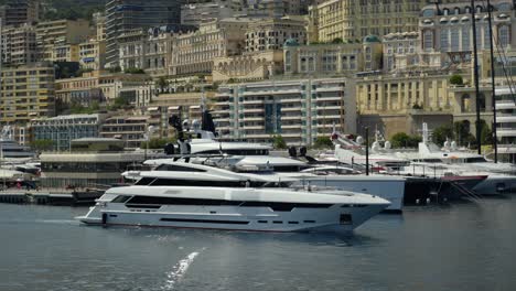 slow panning shot of a private yacht sailing to dock within the monte carlo port