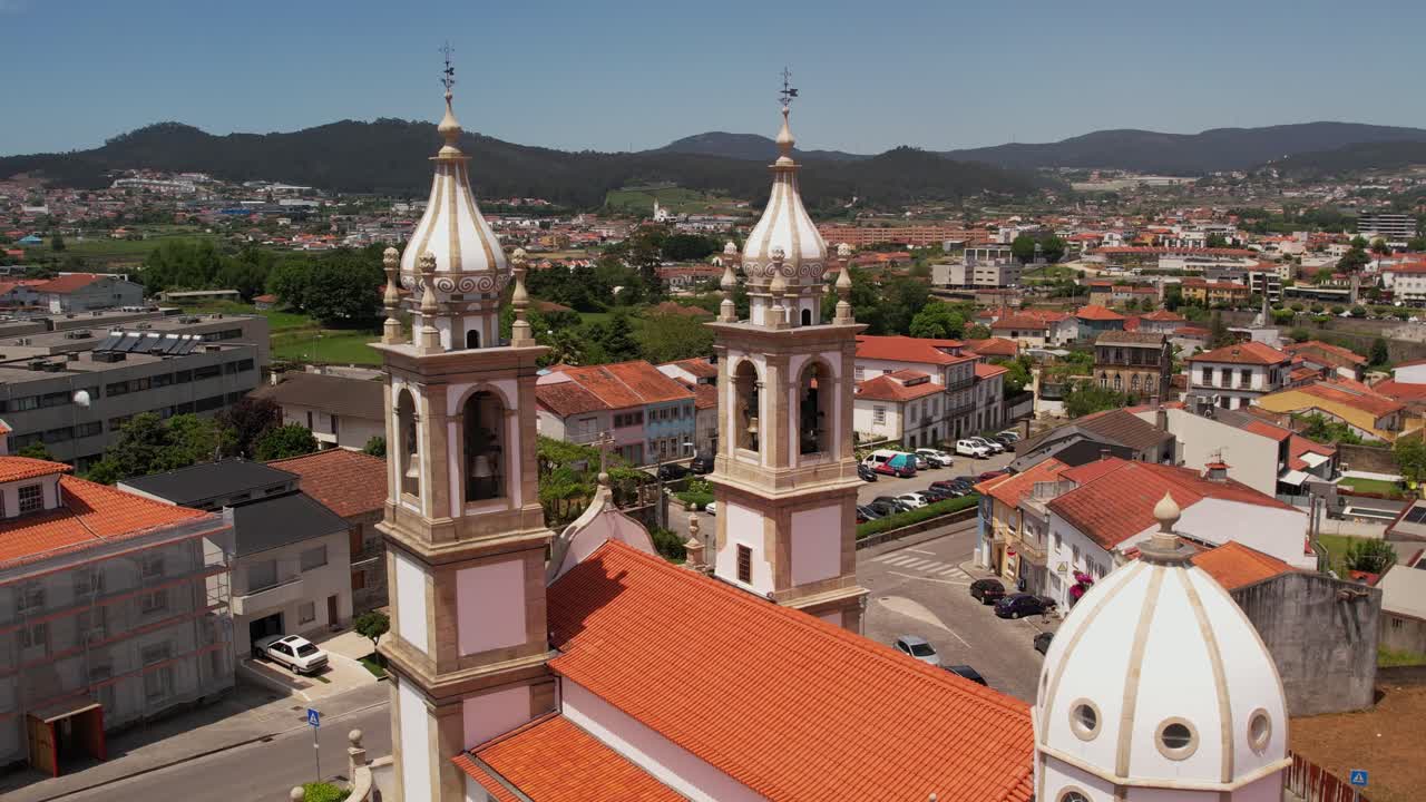 twin bell tower church with surrounding rooftops and city view in Barcelos Portugal