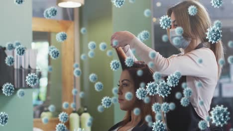 animation of coronavirus cells over caucasian female hairdresser and woman wearing face mask