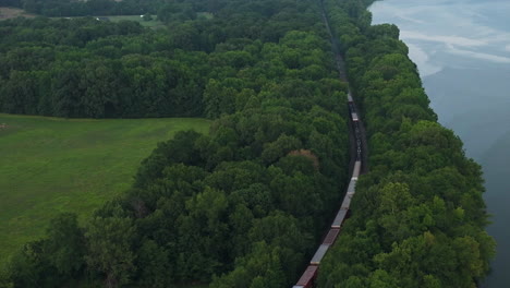 aerial view over train traveling near spadra park in clarksville, arkansas - drone shot