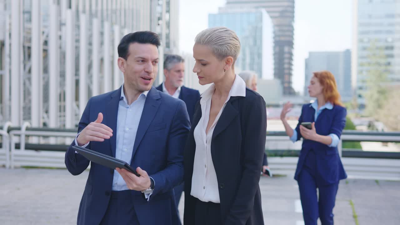 Business Professionals Walking and Discussing Outdoors in a City