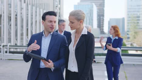 business professionals walking and discussing outdoors in a city