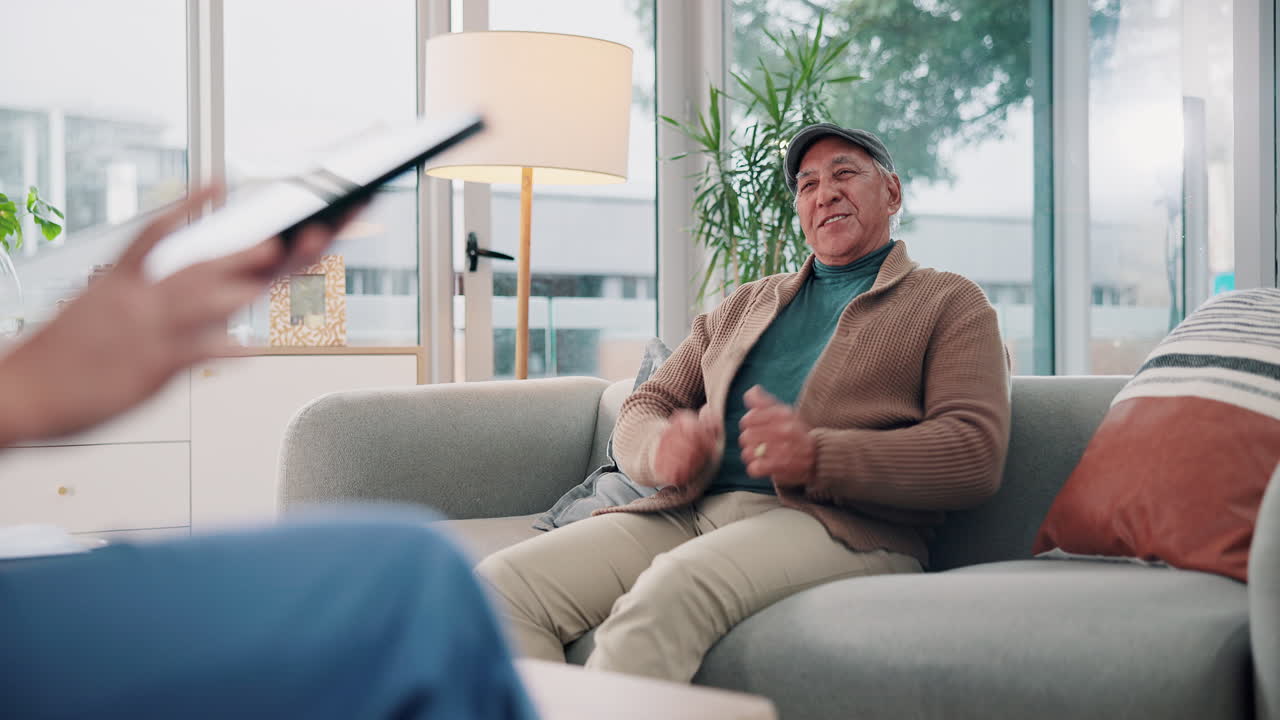 An elderly man receives a home healthcare visit from a doctor