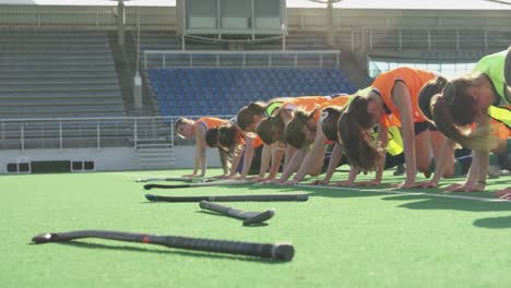 female hockey players warming up on the field