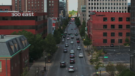 Aerial-drone-view-flying-down-E-Main-St-following-traffic-in-Downtown-Lexington,-Kentucky