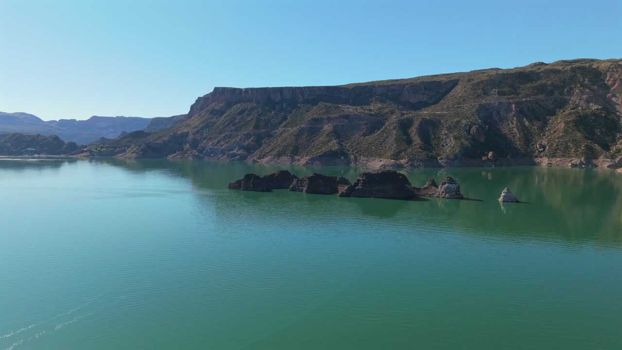 Aerial fly Emerald Lake Landscape in Mendoza Argentina, Atuel Canyon, Valle Grande Reservoir along Rugged Cliffs