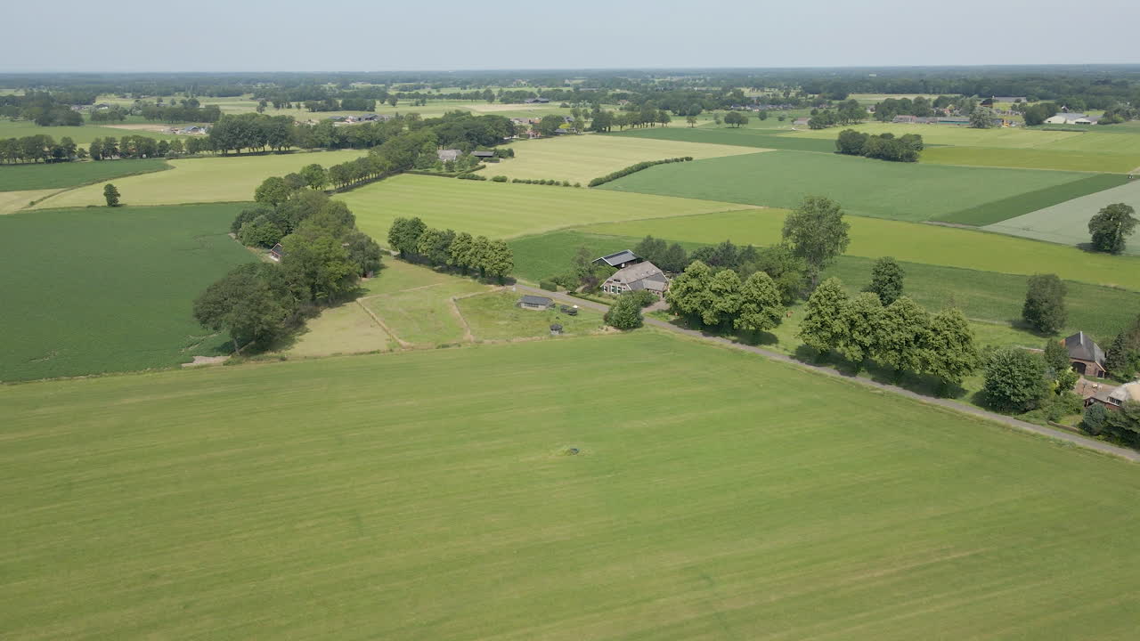 Flying towards beautiful old farm in a rural part of the Netherlands