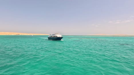 Tourist-ferry-boat-cross-water-outside-of-Egypt-carrying-luxury-travelers-at-midday