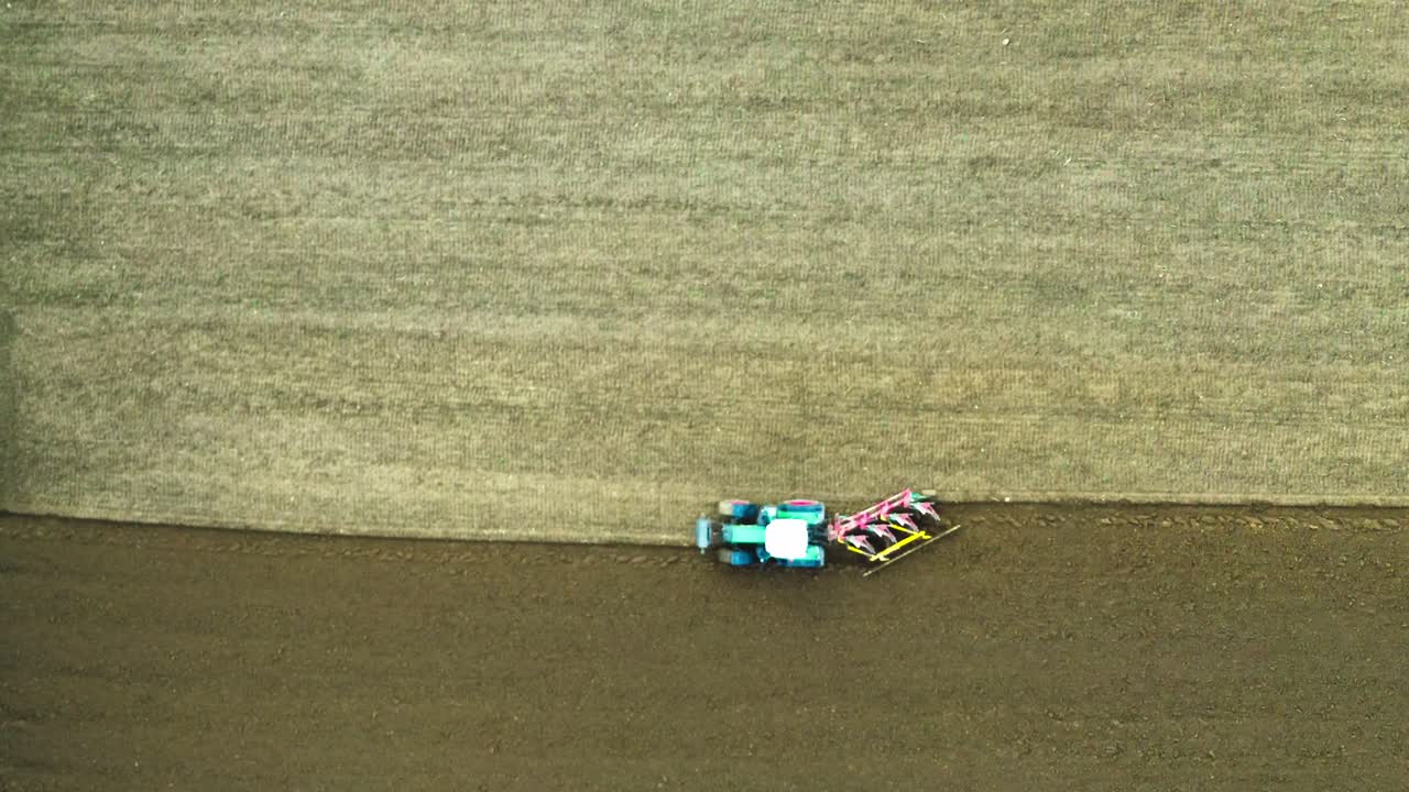 drone fly over field plowing tractor 4k