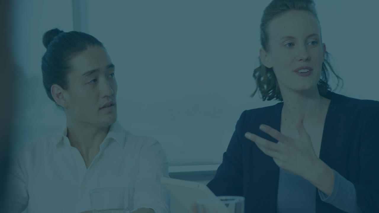 Woman presenting at finance meeting showing transparent chart with rising red and blue percentages