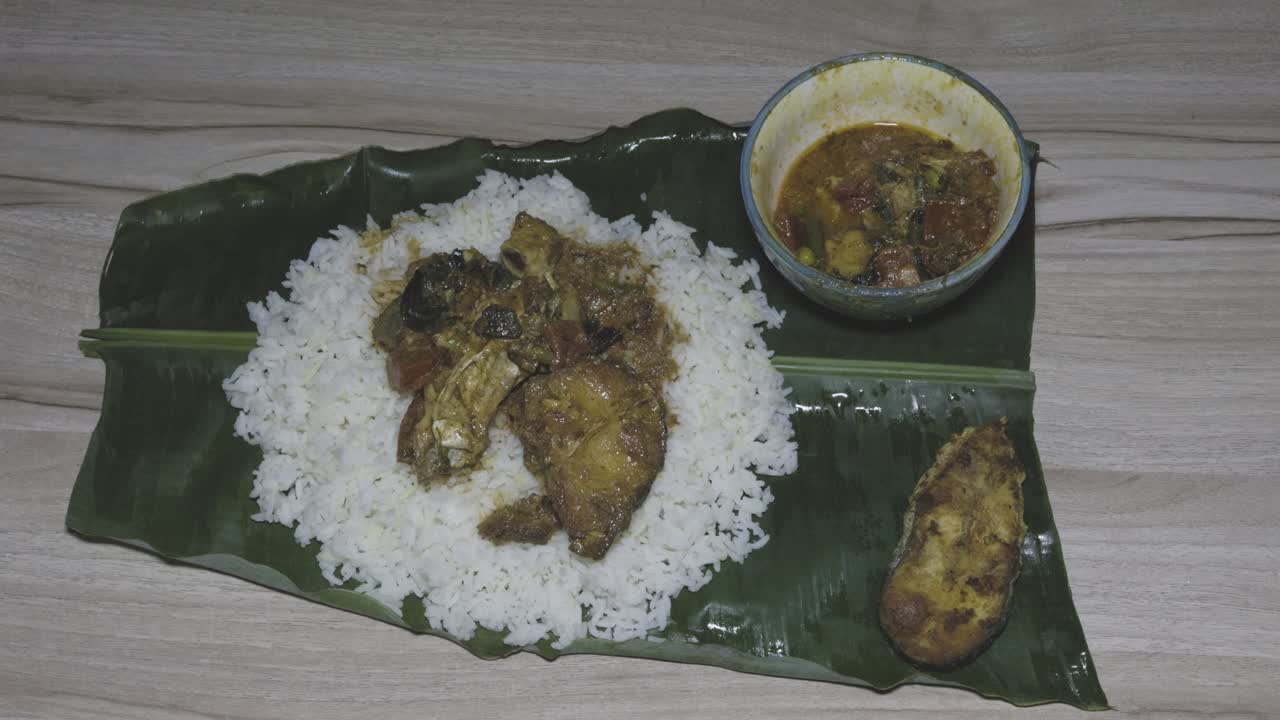 fresh and hot fish and rice cooked meal served at banana leaf for dinner